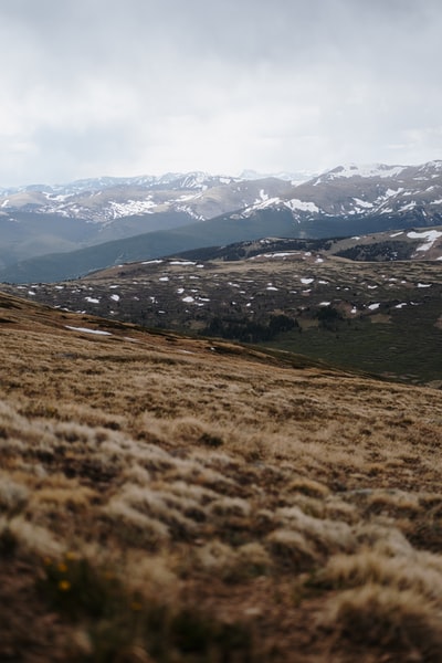 During the day, the snow mountain near the grass field
